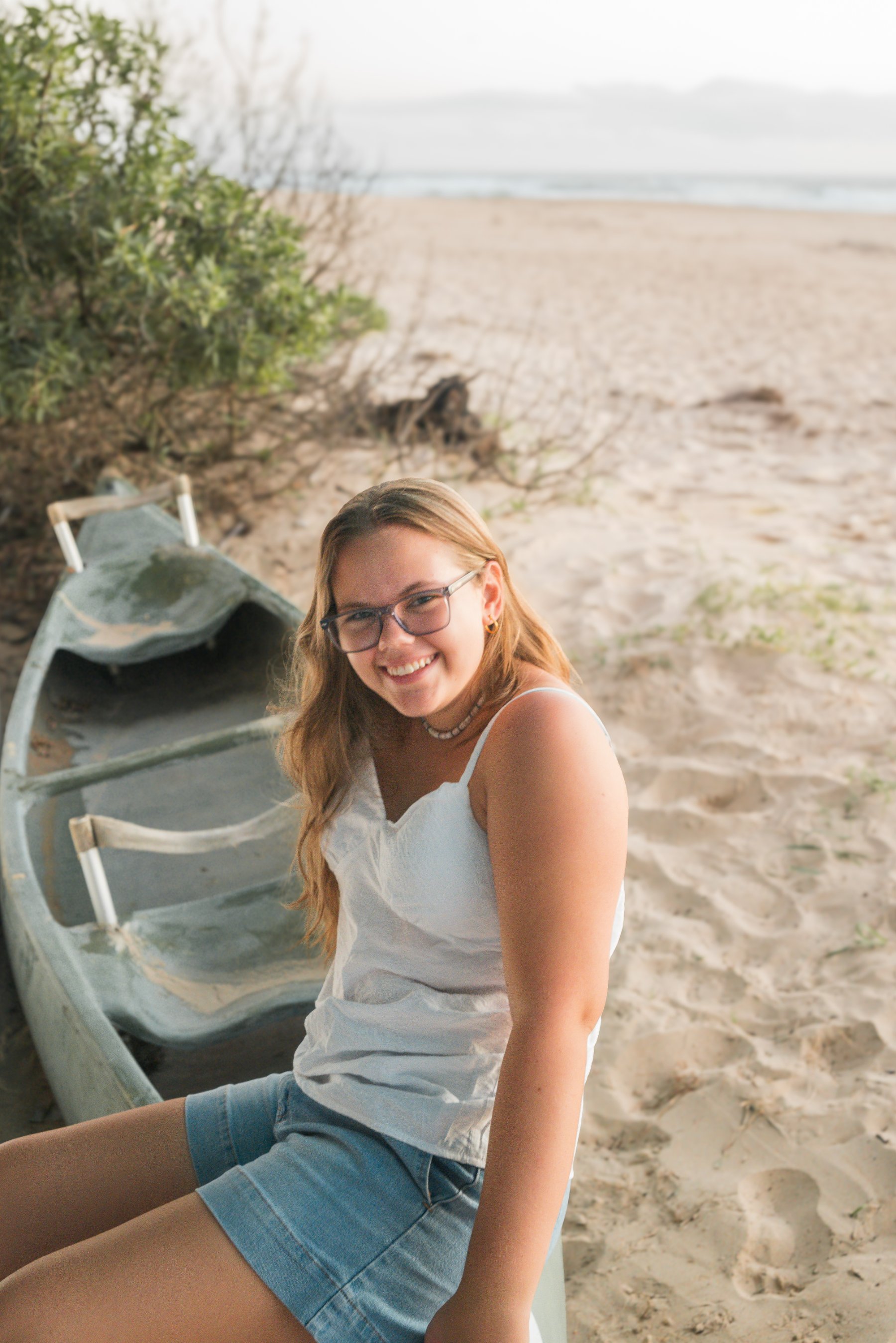 Senior portrait sitting beside a boat by Christa V Photography